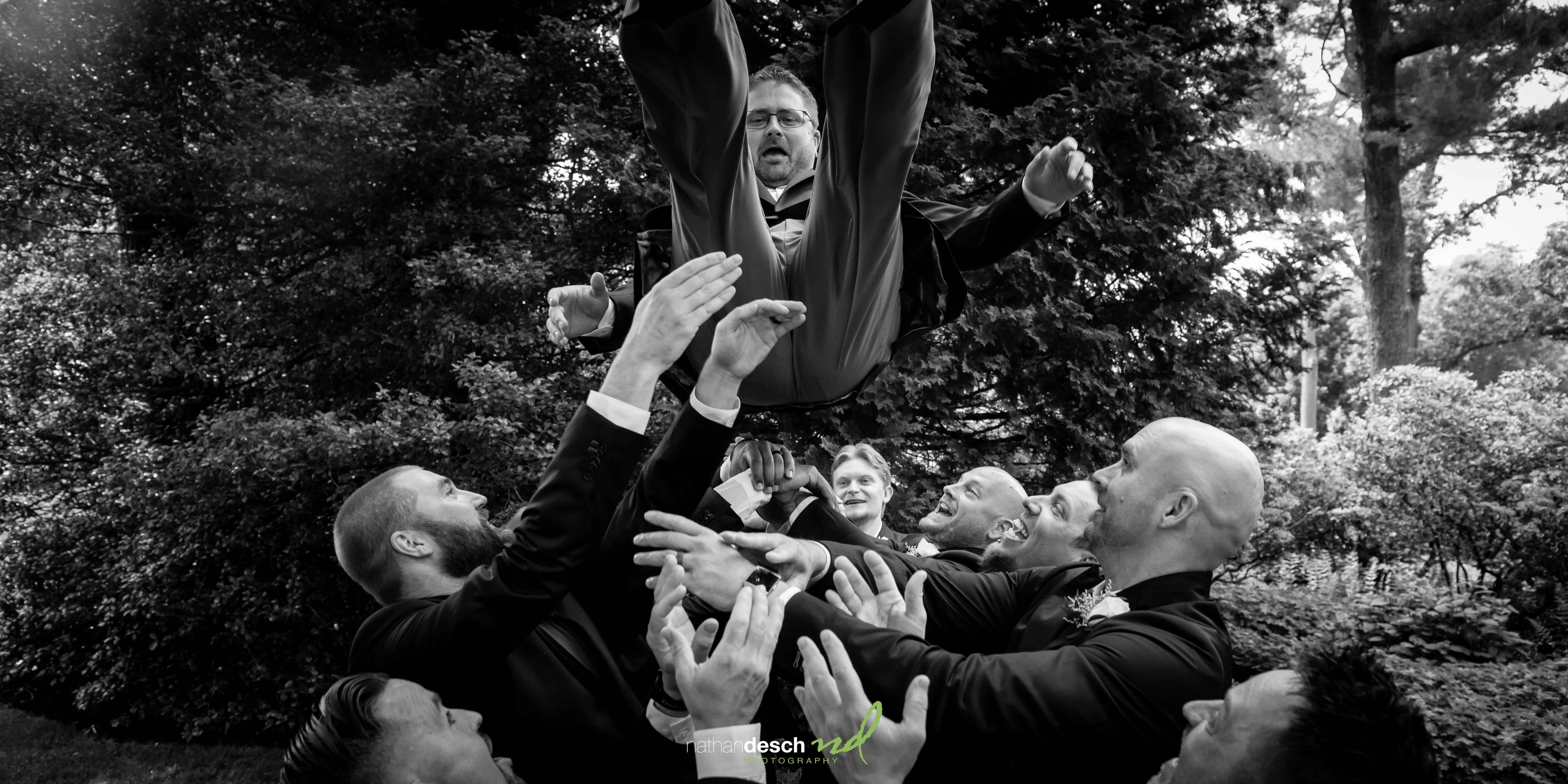 groom being tossed in the air