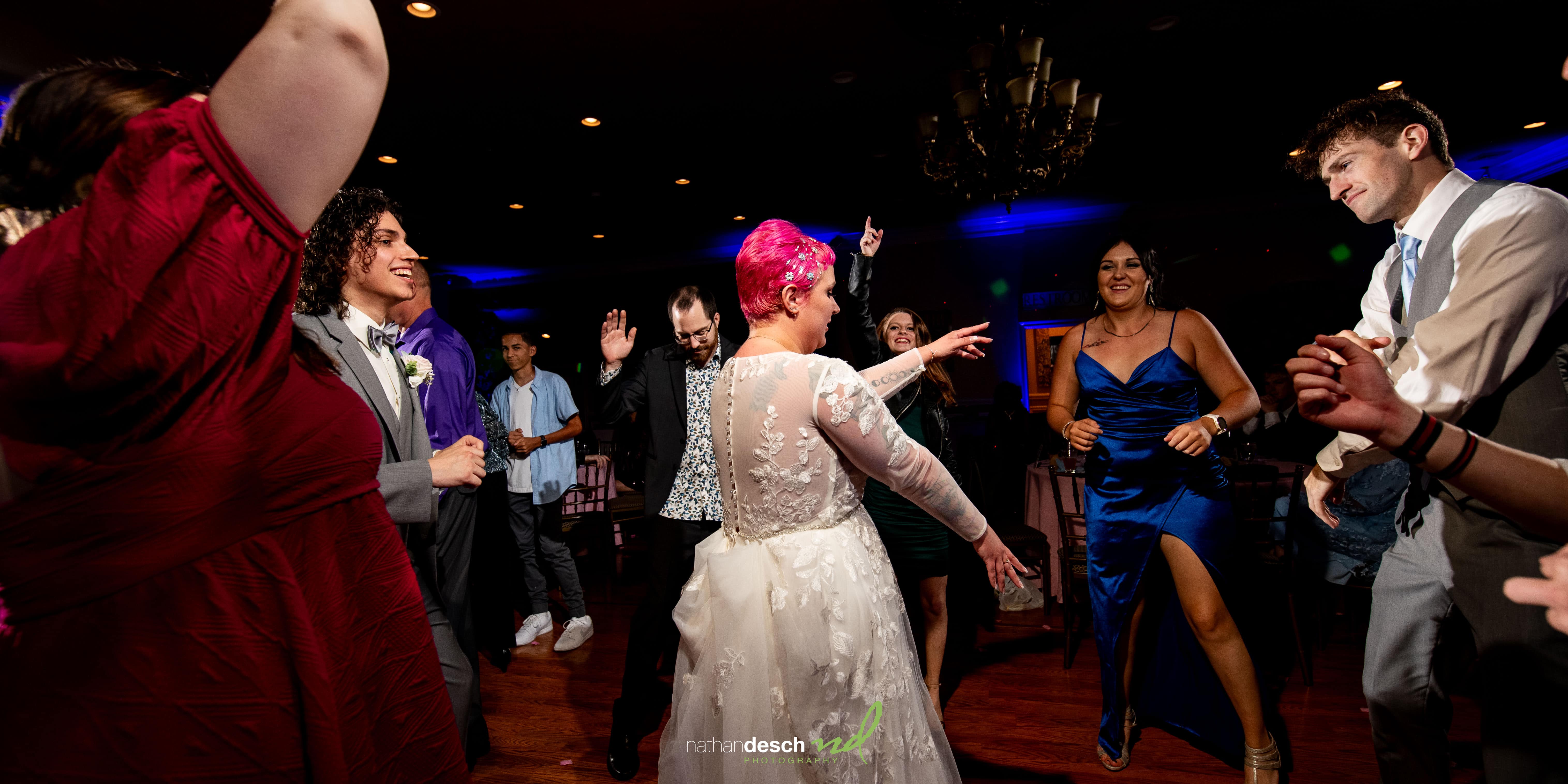 bride with pink hair dancing