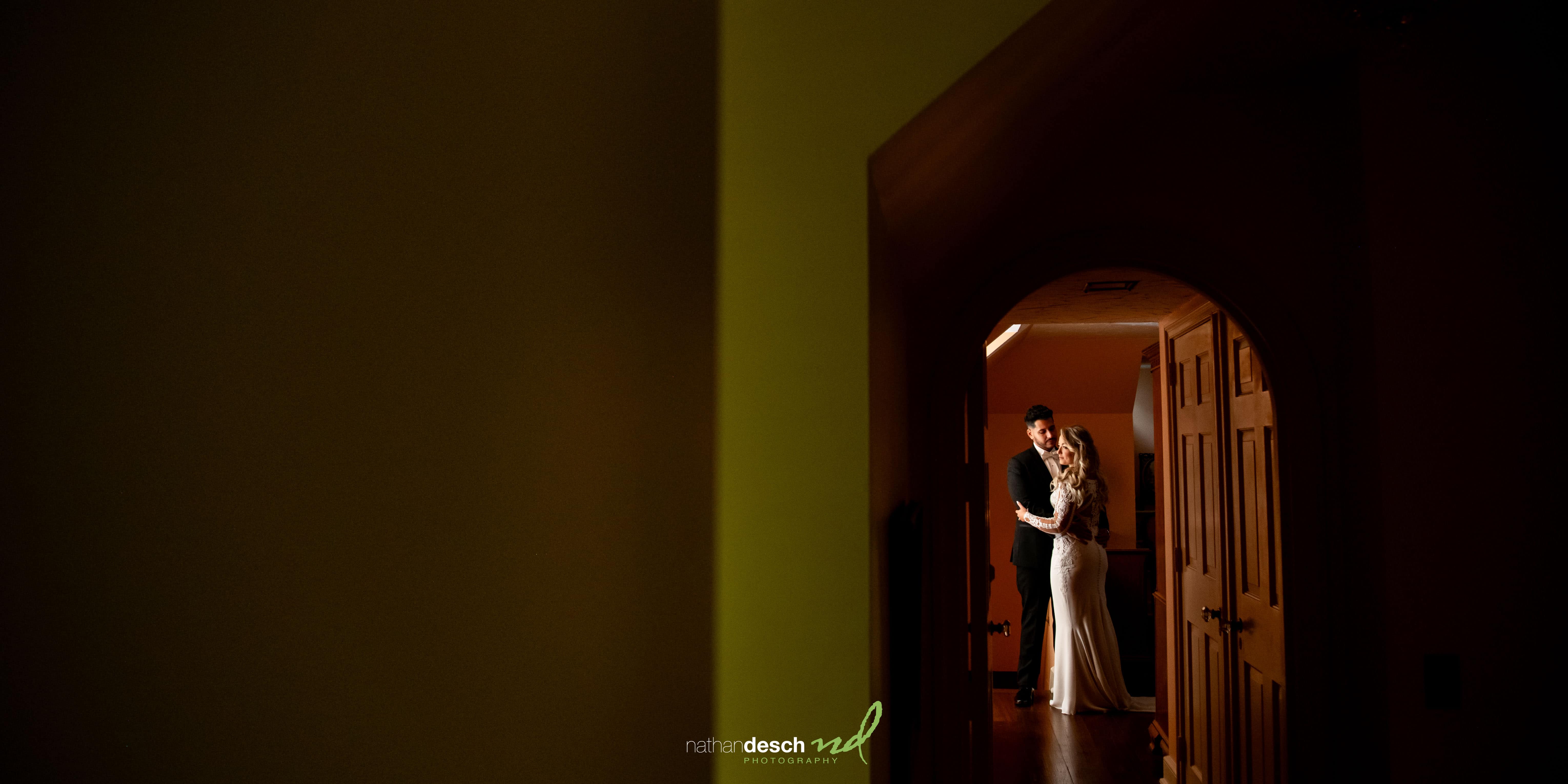 Bride and groom portrait by window