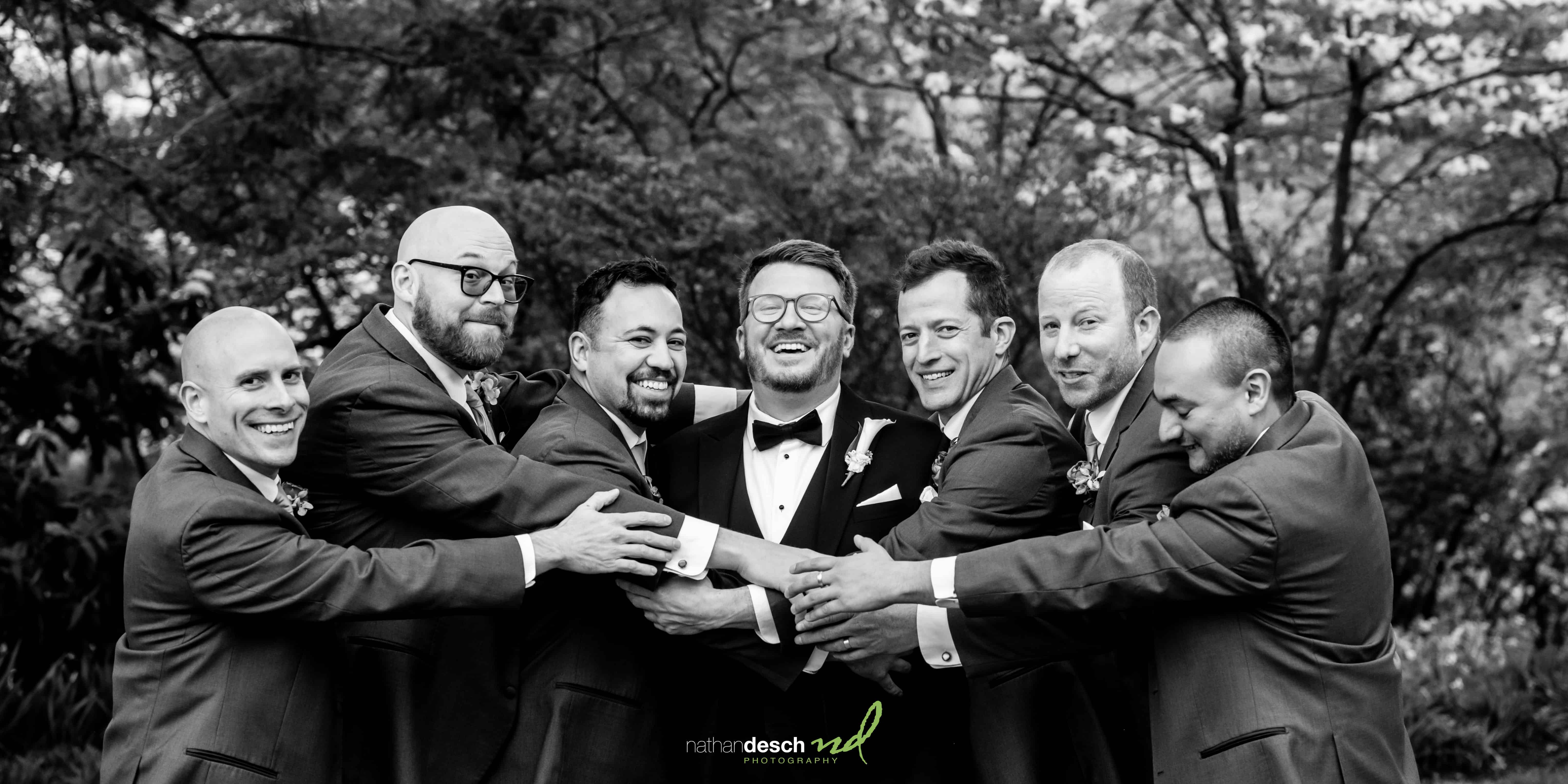 Groomsmen hugging groom