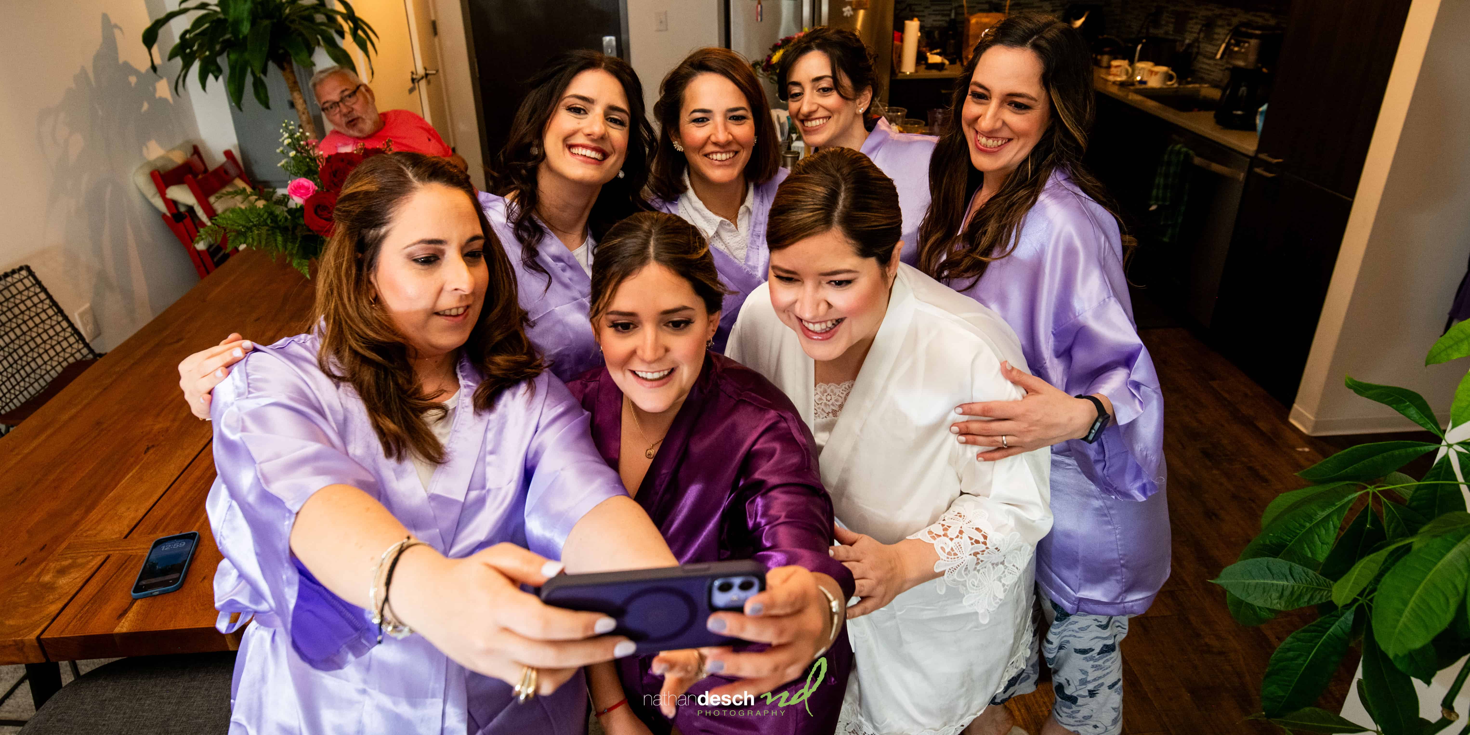 Bride taking selfie with Bridesmaids