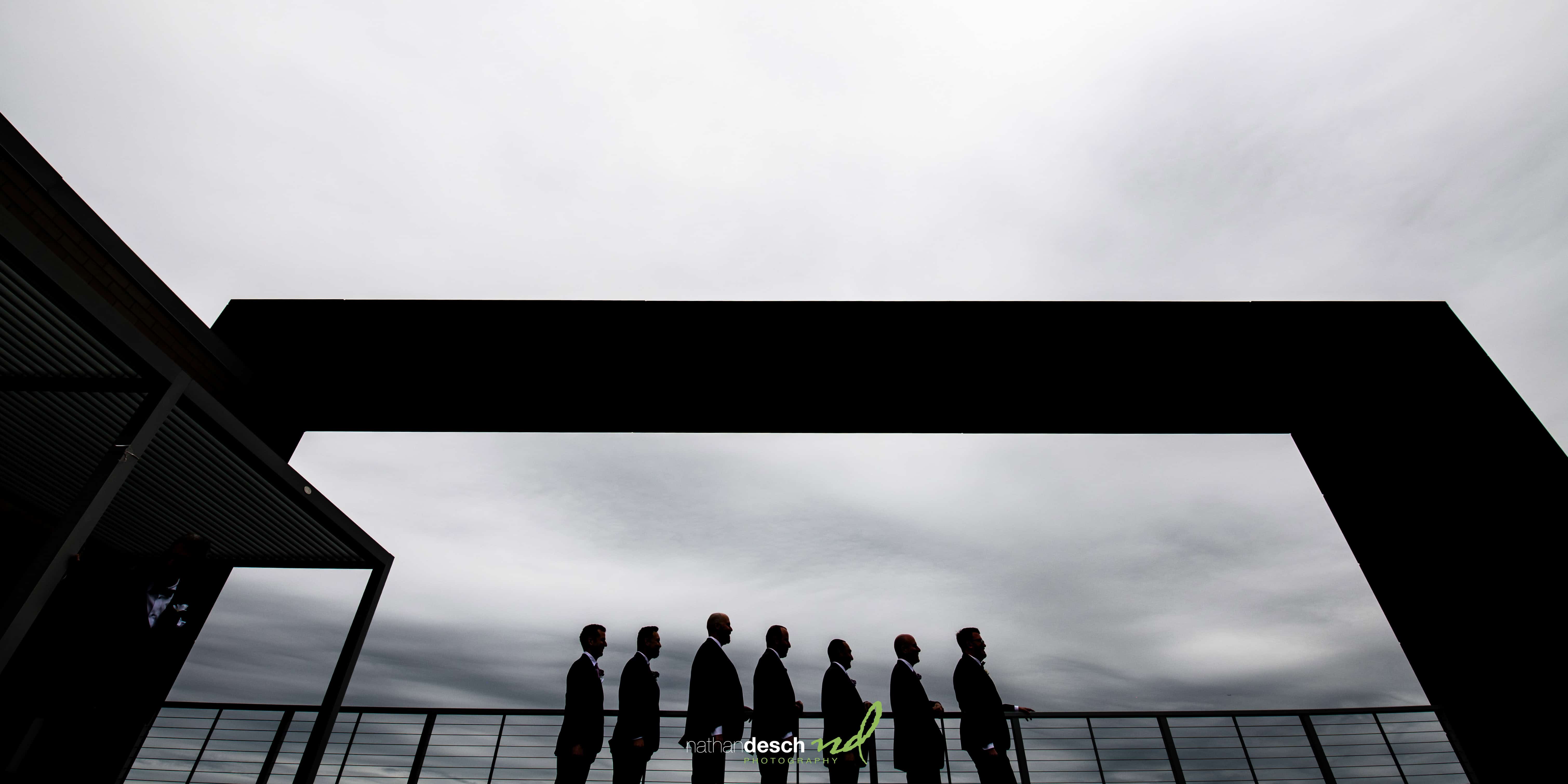 groom and groomsmen on roof of building in Philadelphia