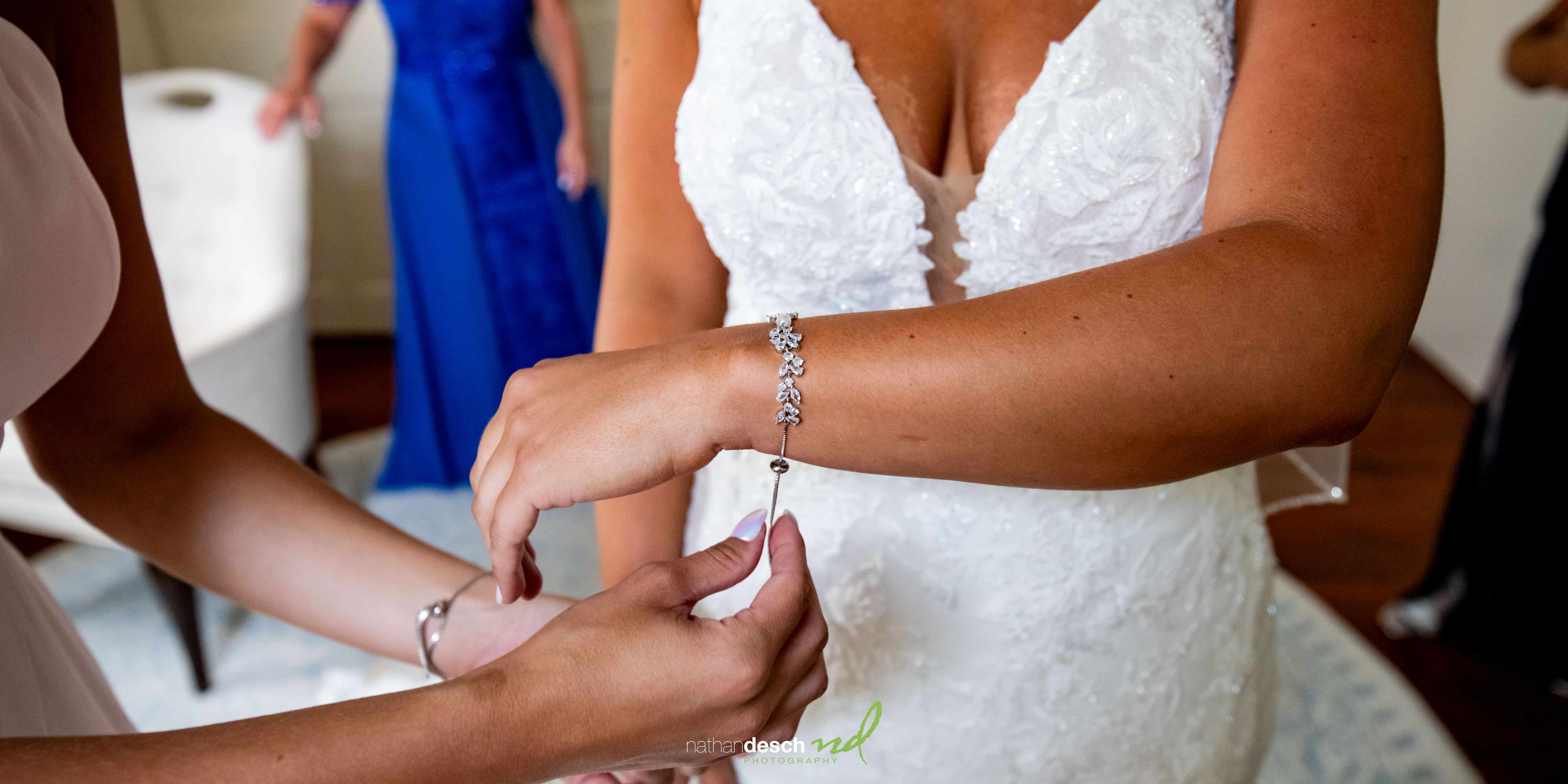 Bride putting on jewelry