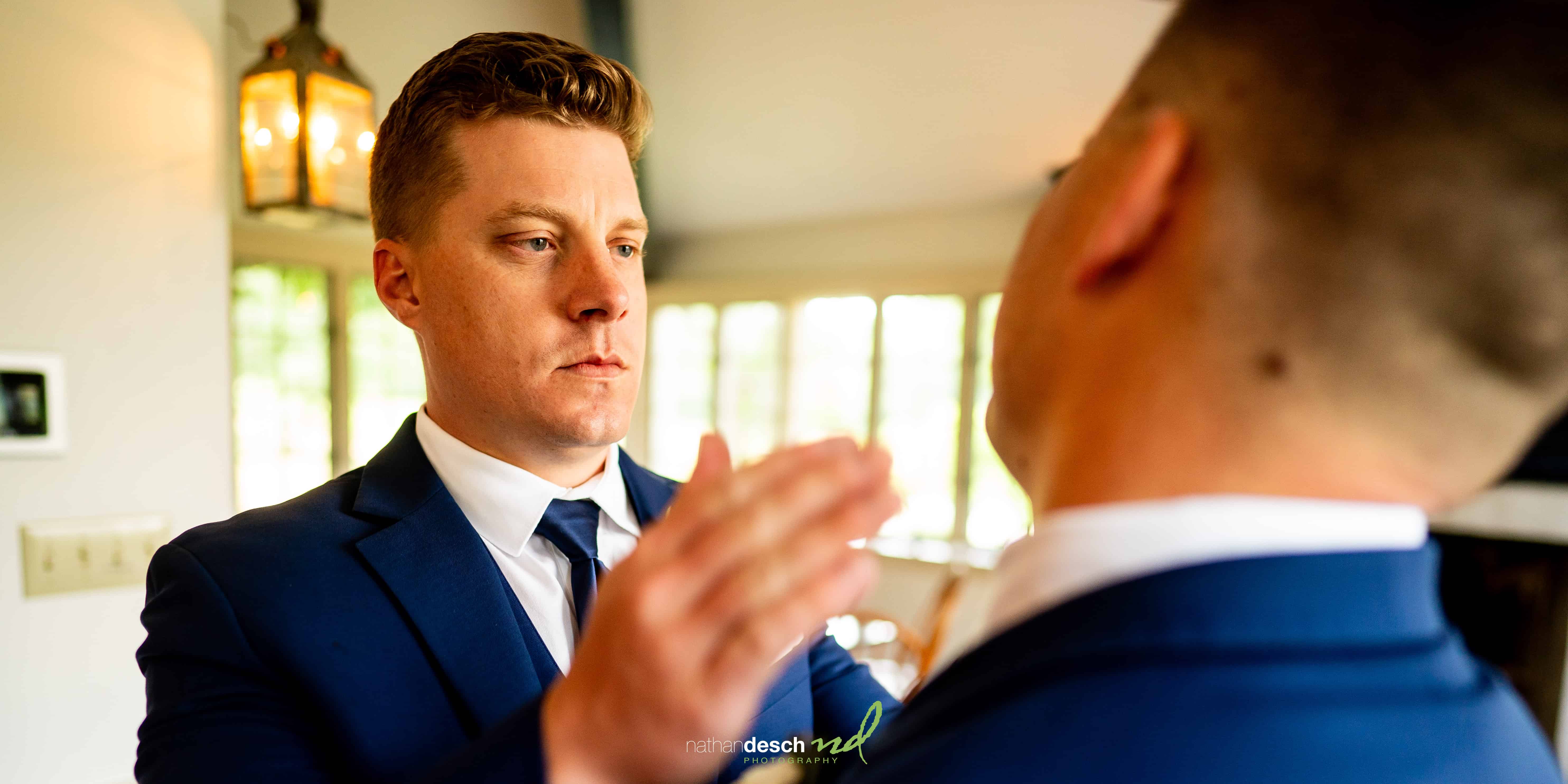 Groom being helped by brother