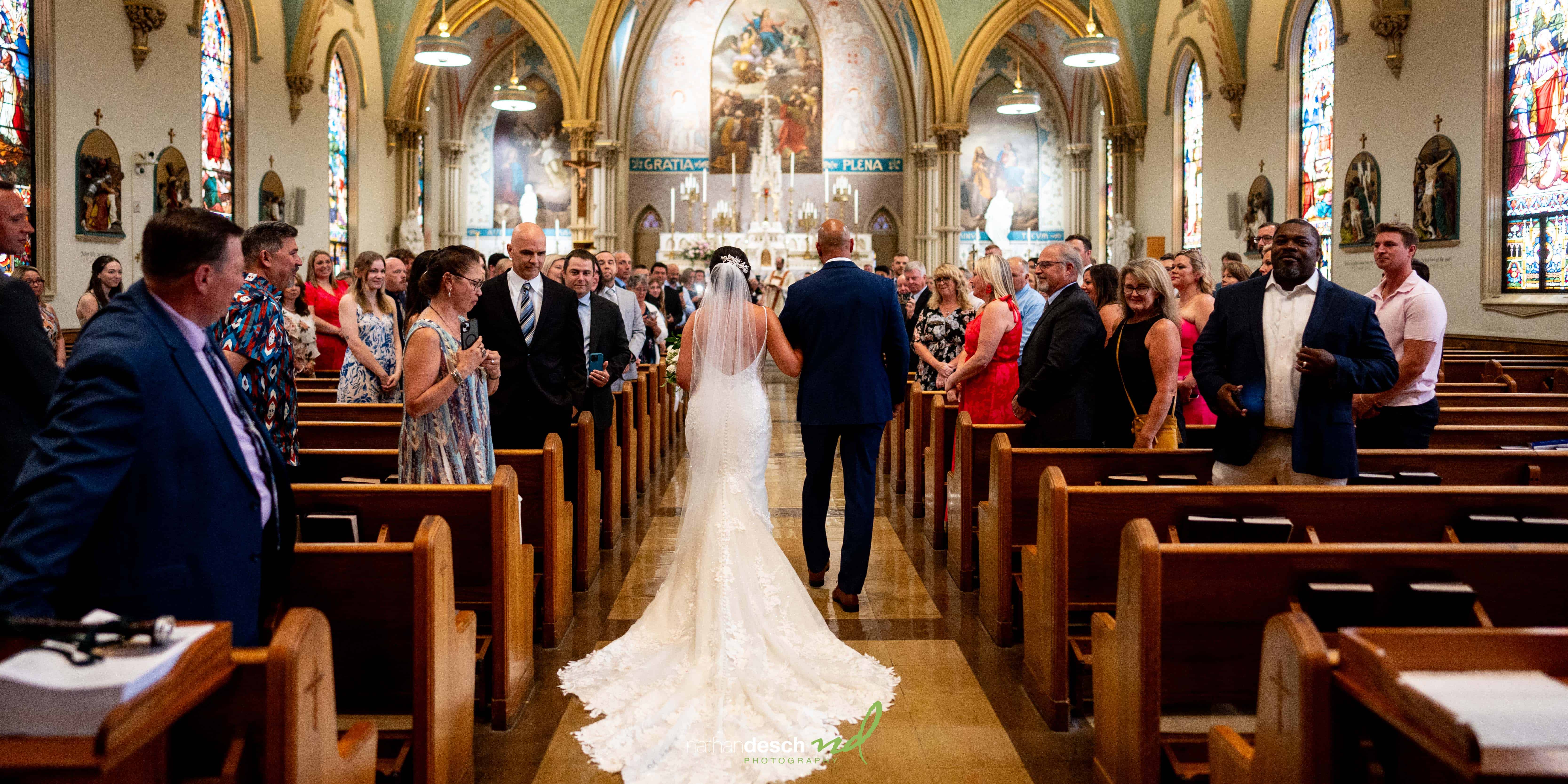 backs of bride and father coming down the aisle