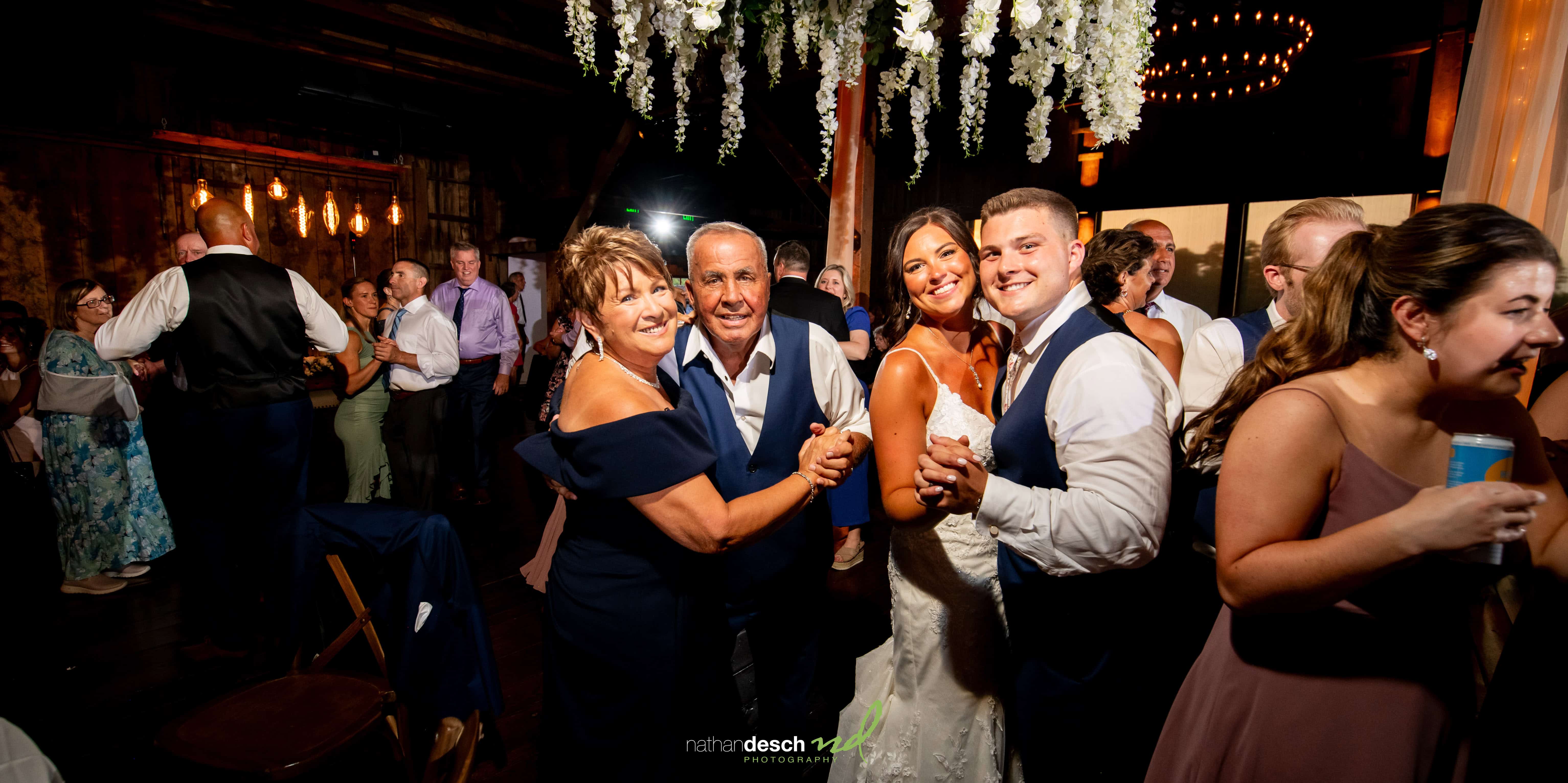 Bride and groom with grandparents at the farm at eagles ridge