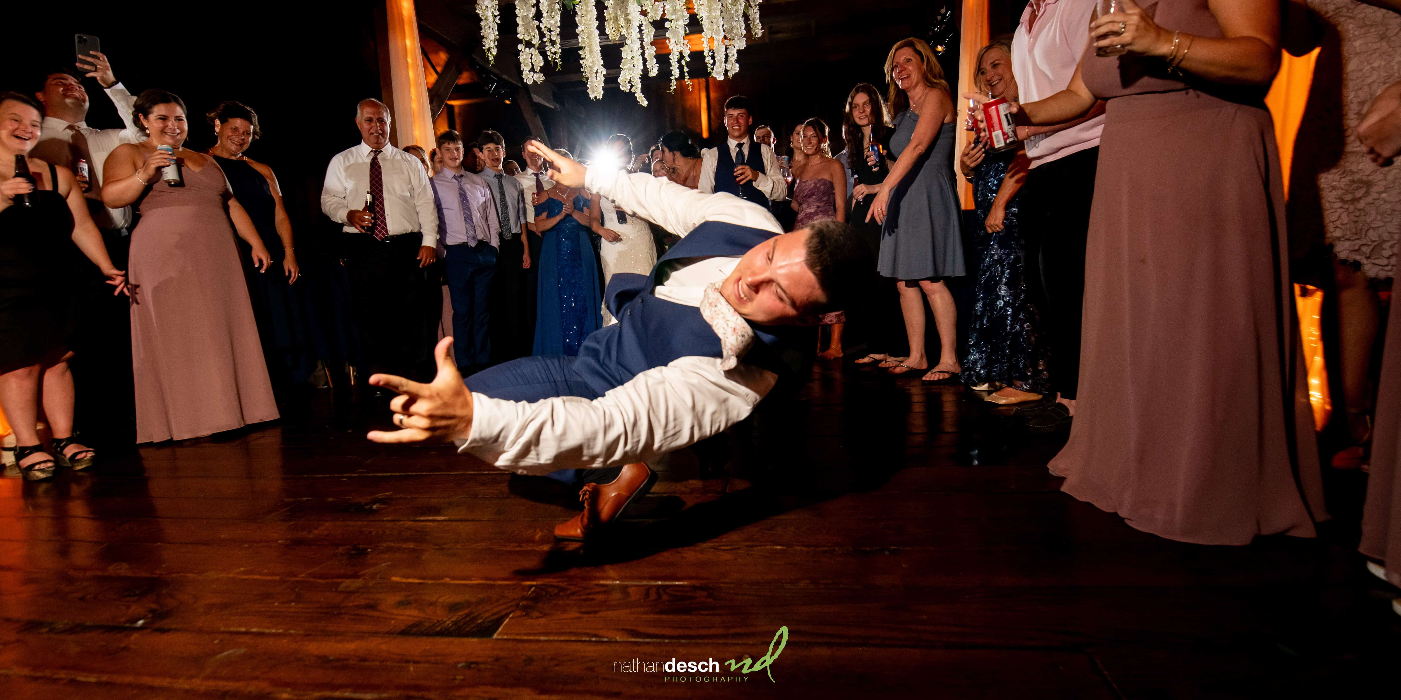 Groom breakdancing at wedding