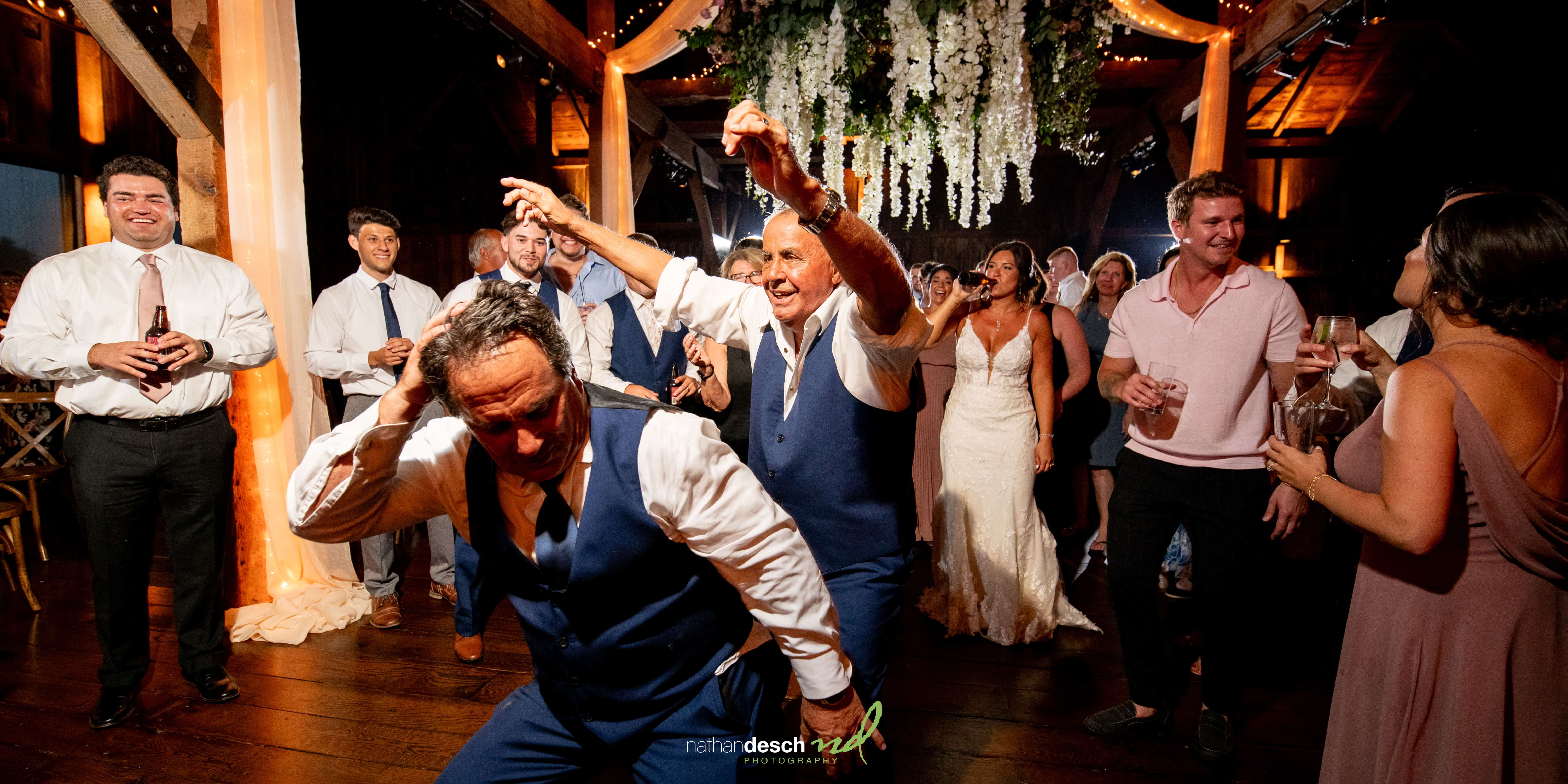 Father and grandfather dancing at wedding