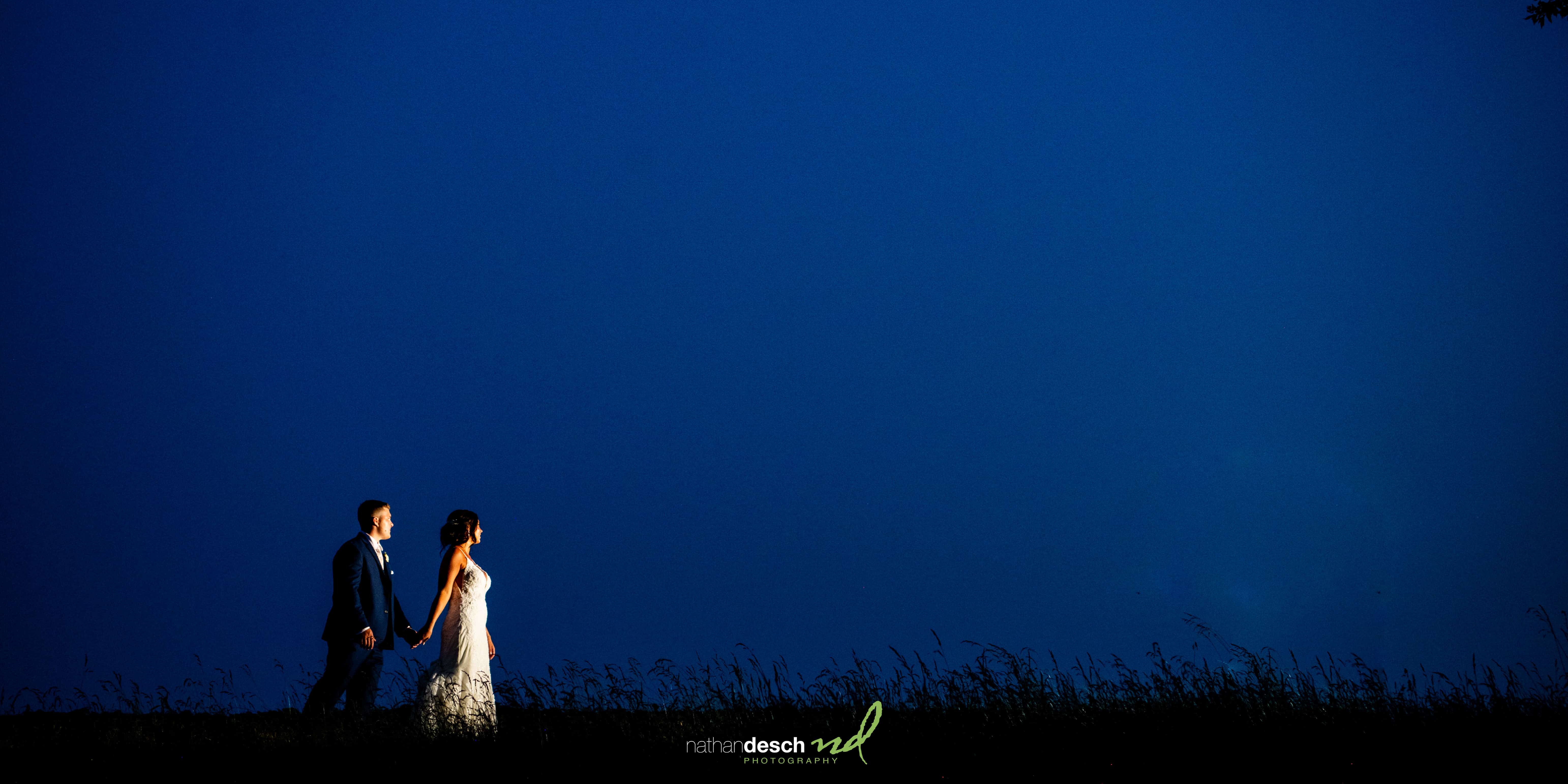 bride and groom walking at dusk