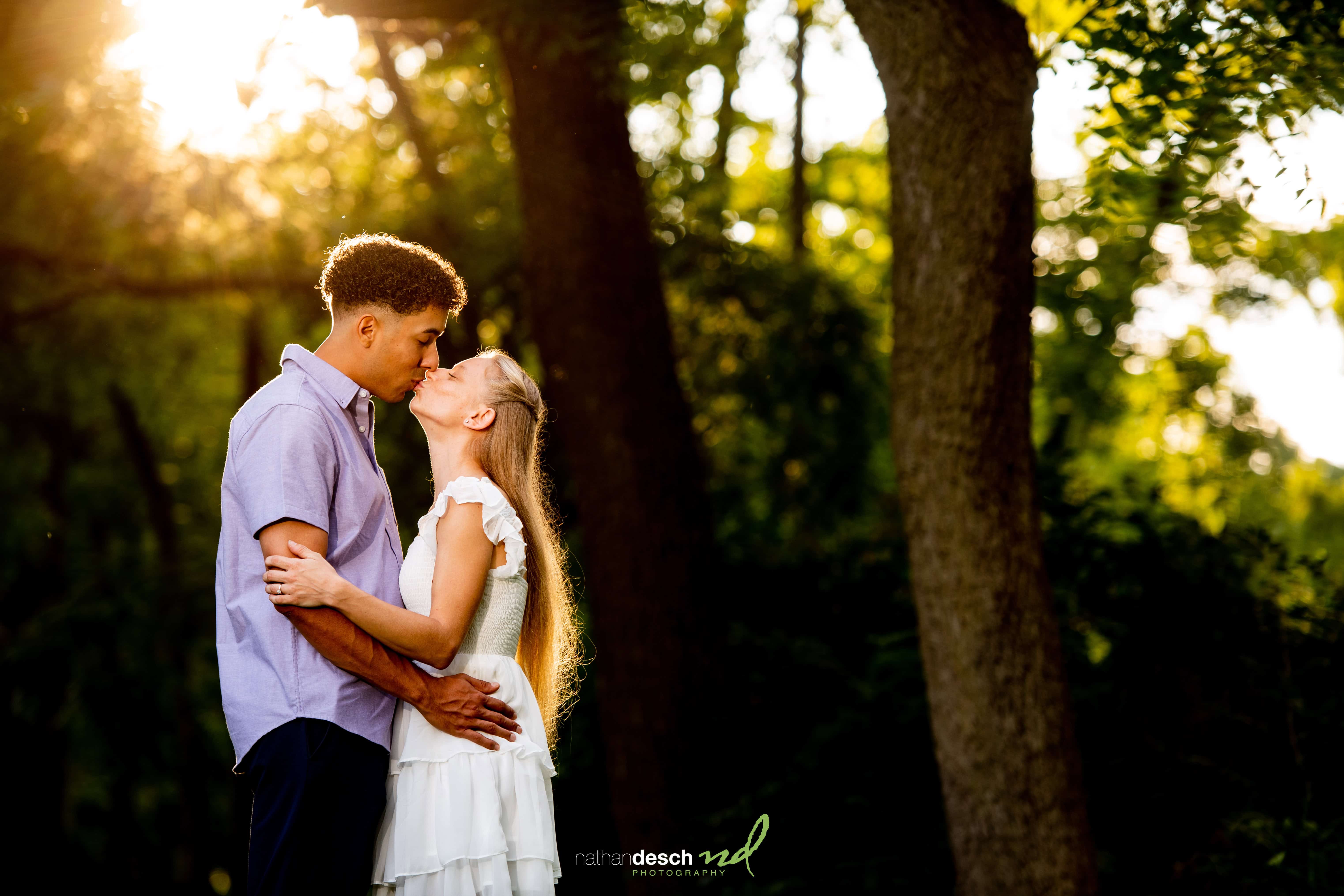 engaged couple kissing