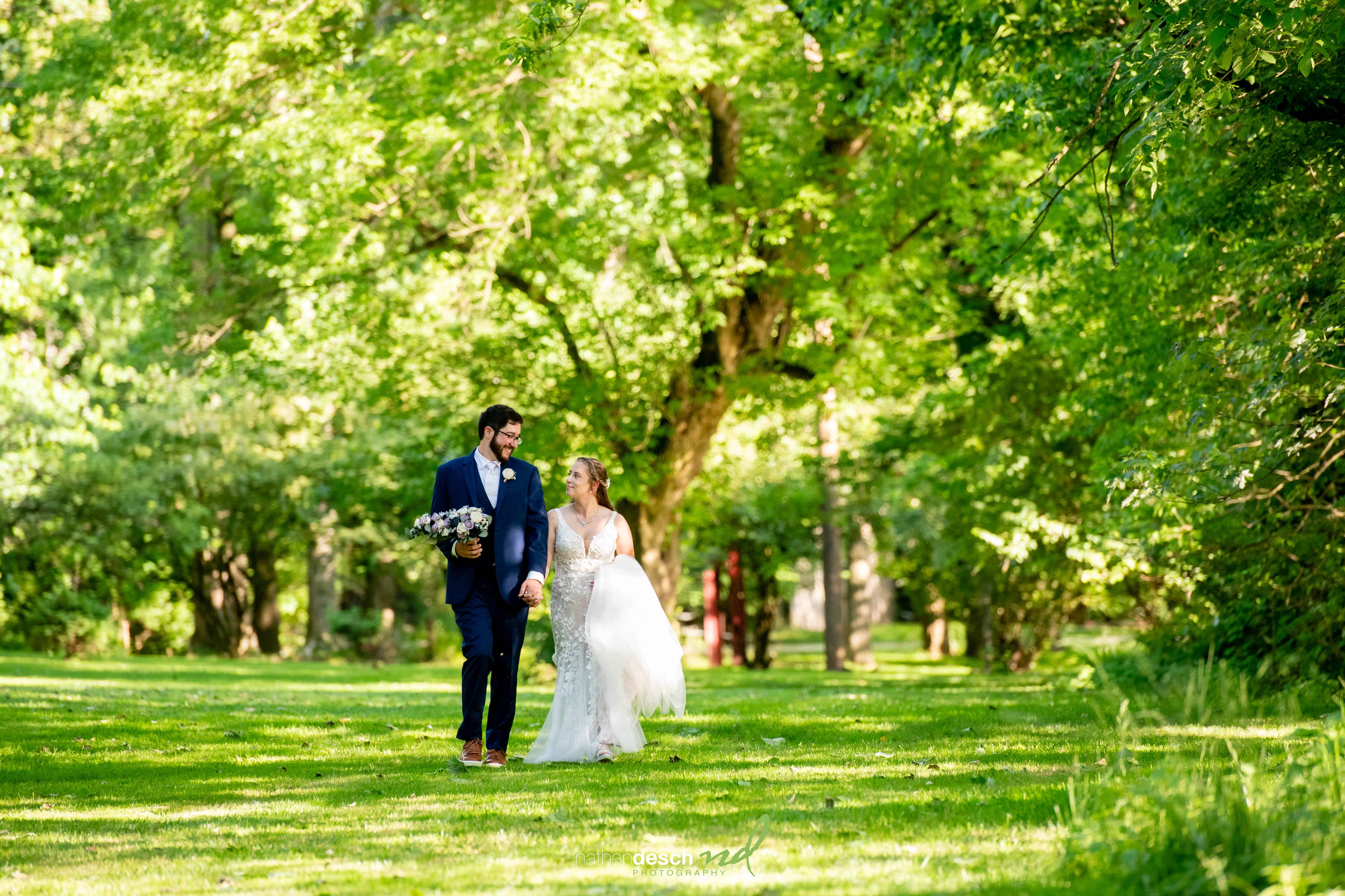 bride and groom walking at riverdale manor