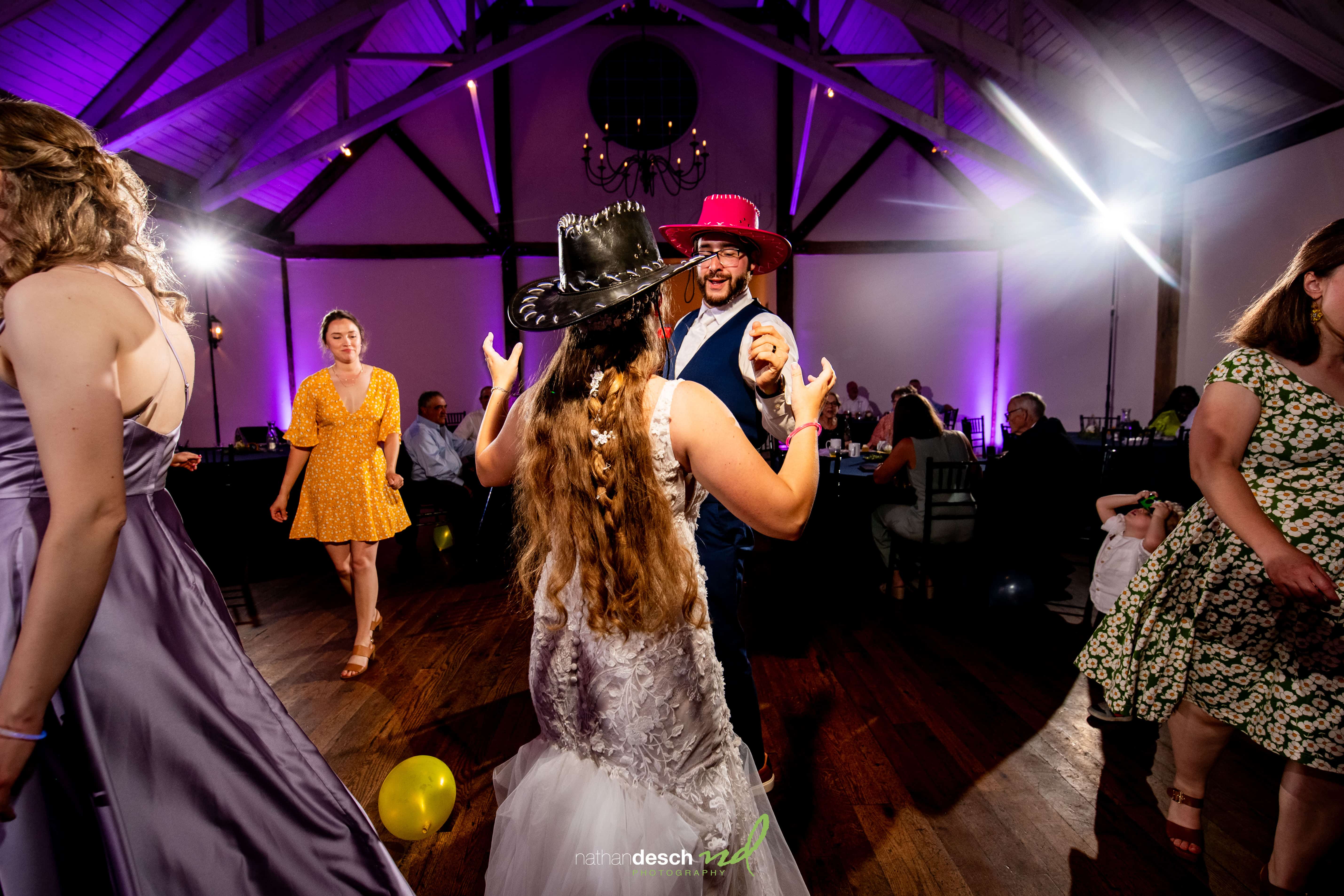 bride and groom with cowboy hats